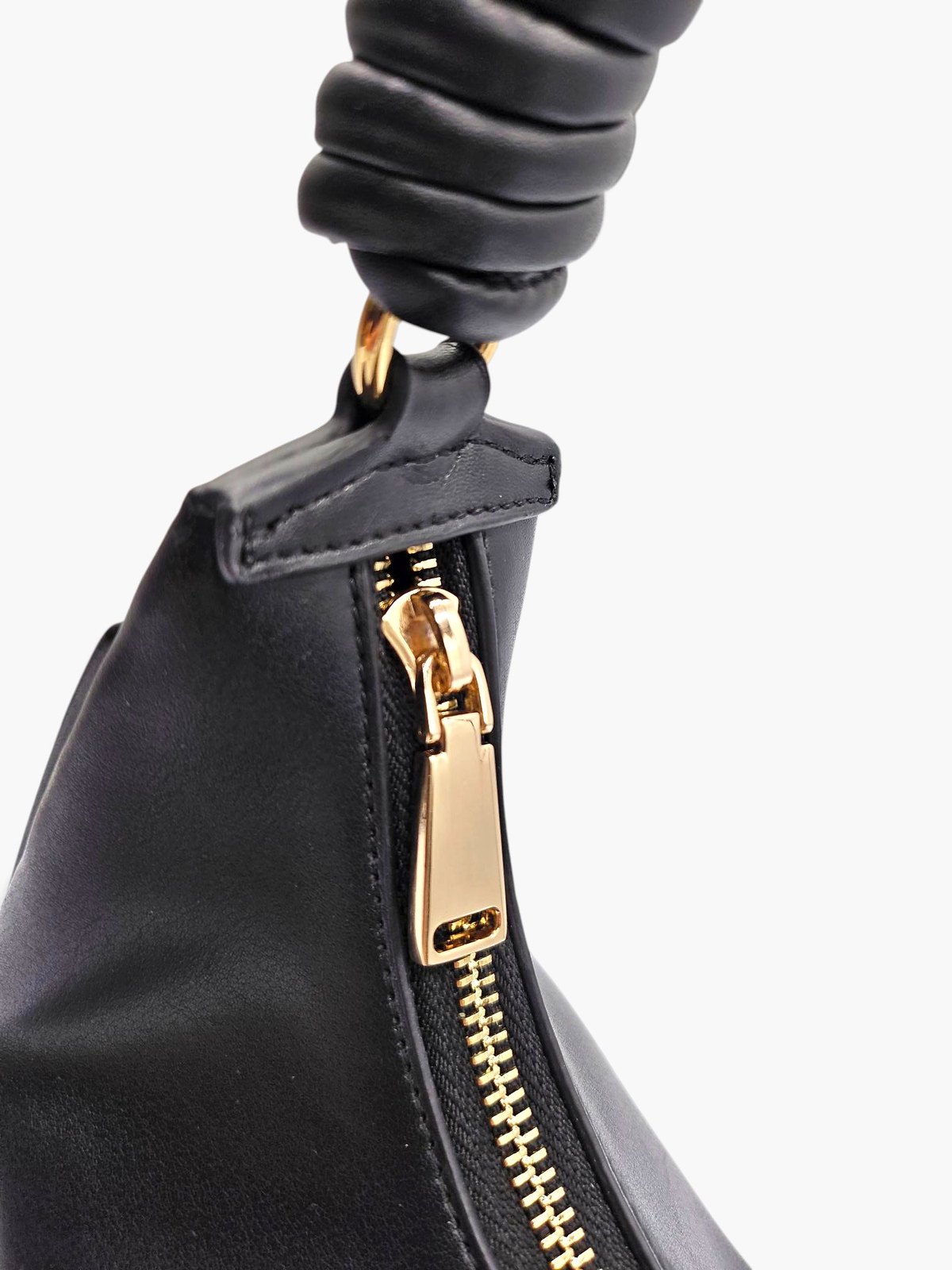 Close-up of The.CP's gold-coloured top zip and pull