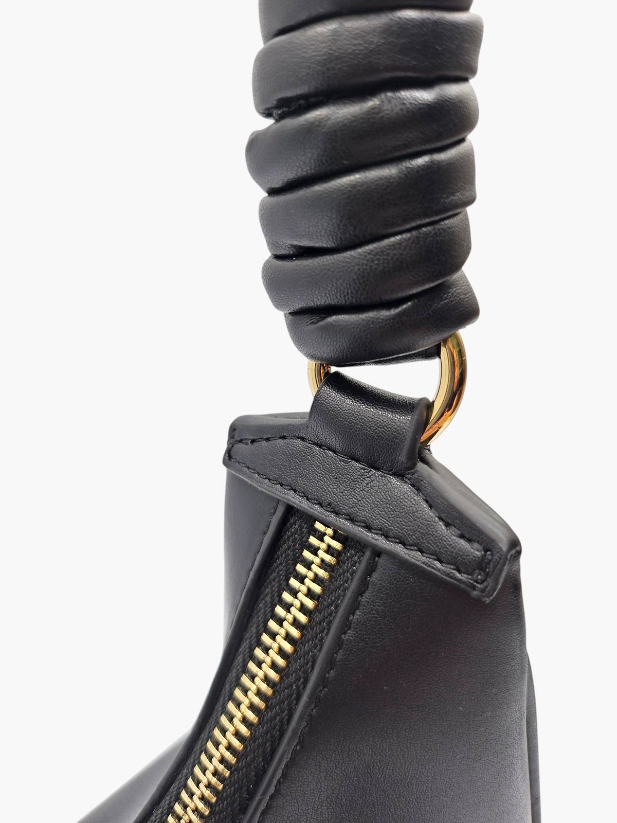 Close-up of the gold-coloured ring joining The.CP's strap to its body