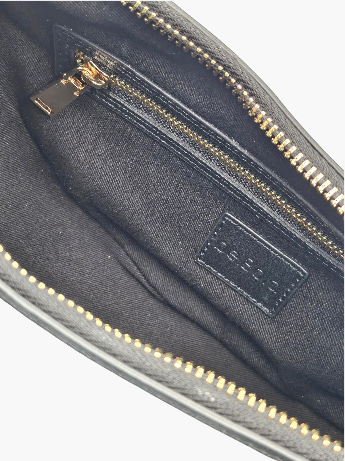 The.CP opened to show its cotton lining and zipped interior pocket