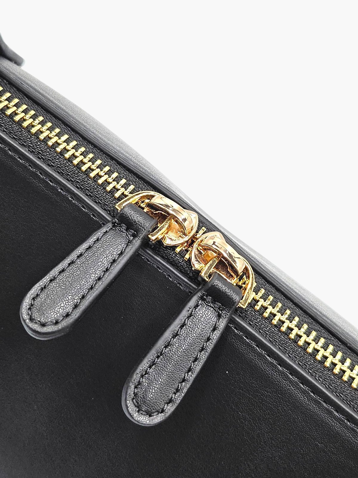 Close-up of The.KDD's two gold-coloured top zips