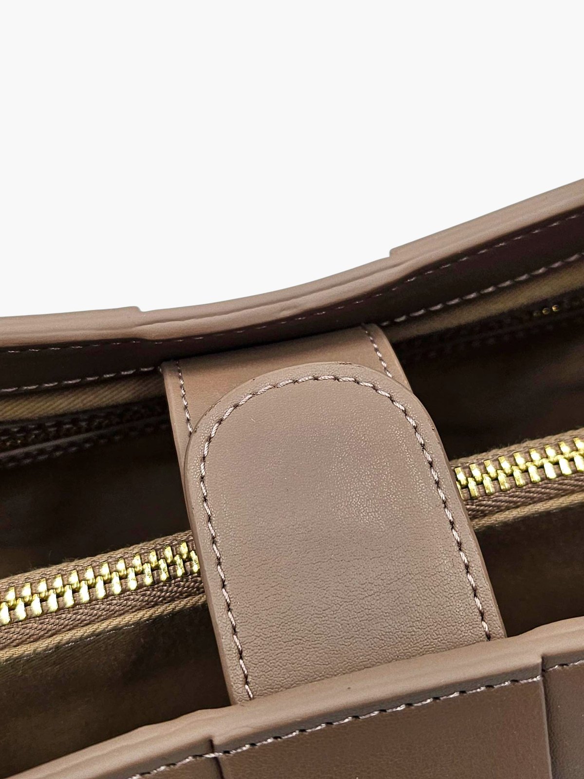 Close-up of the leather tab that fastens across The.KTP's middle compartment
